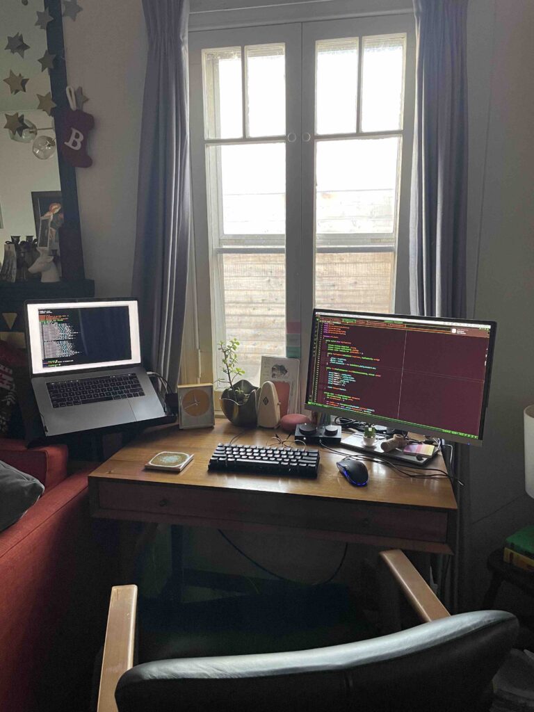 willems' at home office desk with code on his dual monitors